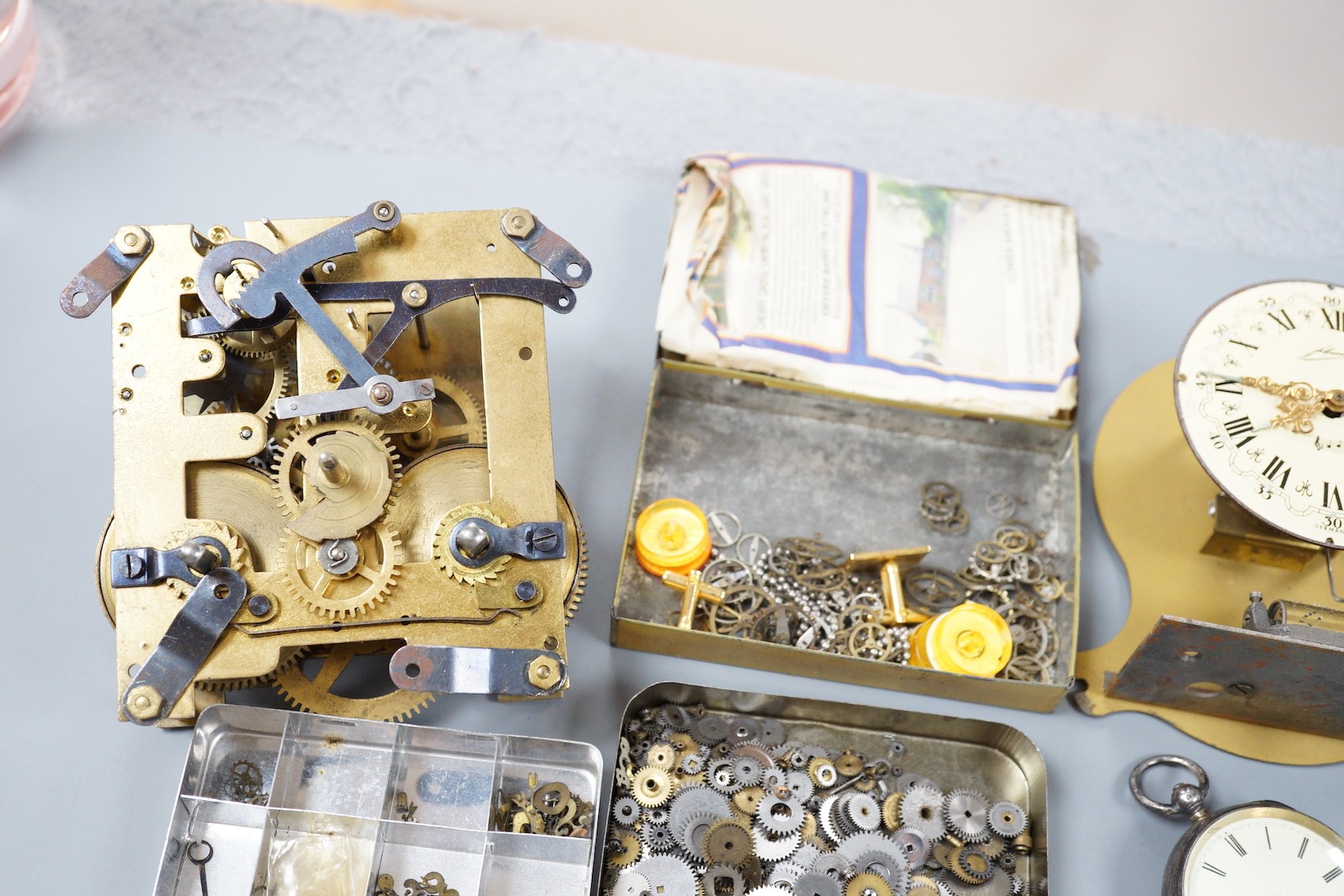 A silver pocket watch, various wrist watches and watch and clock parts and movements